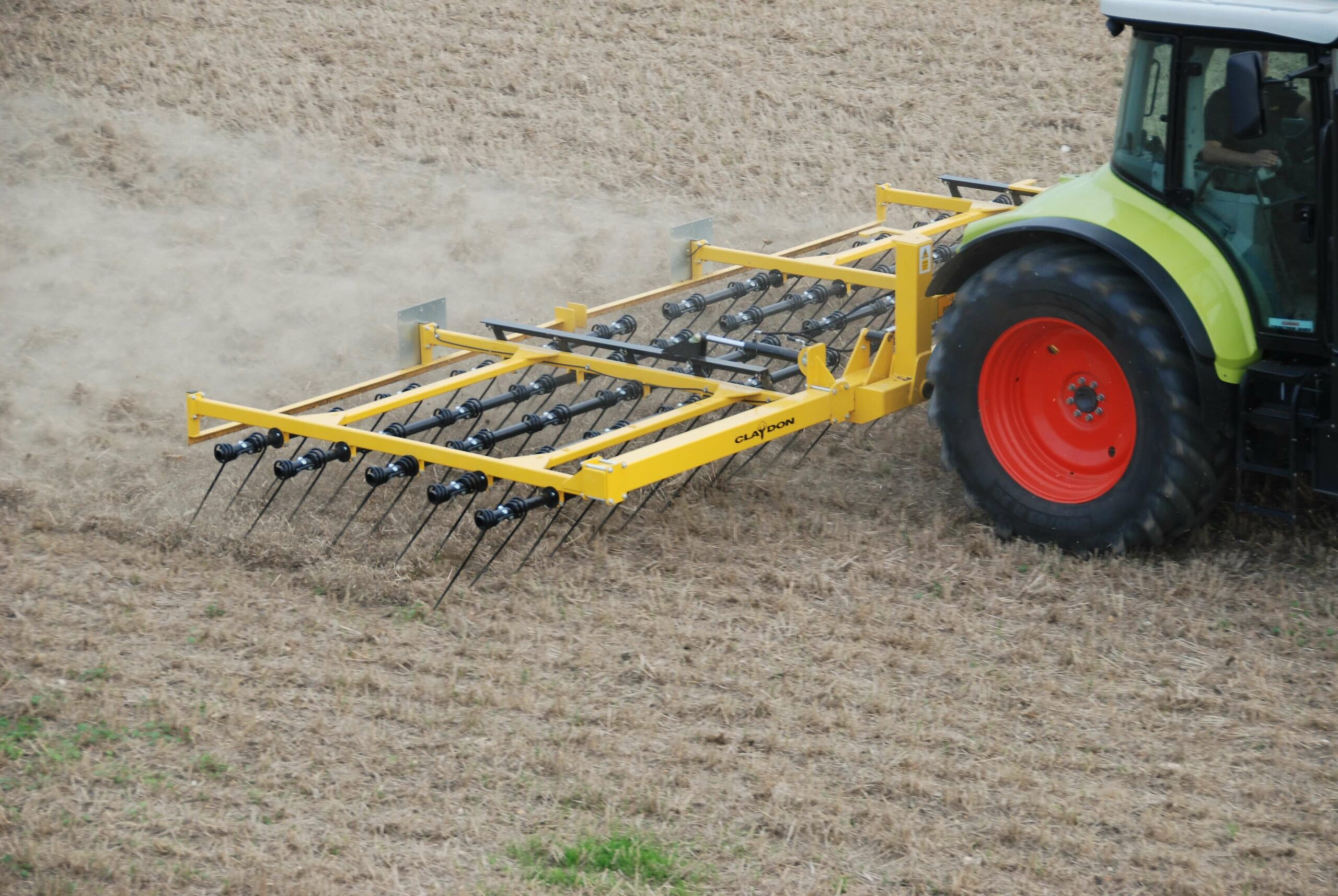straw harrow machine is in operation on the farm